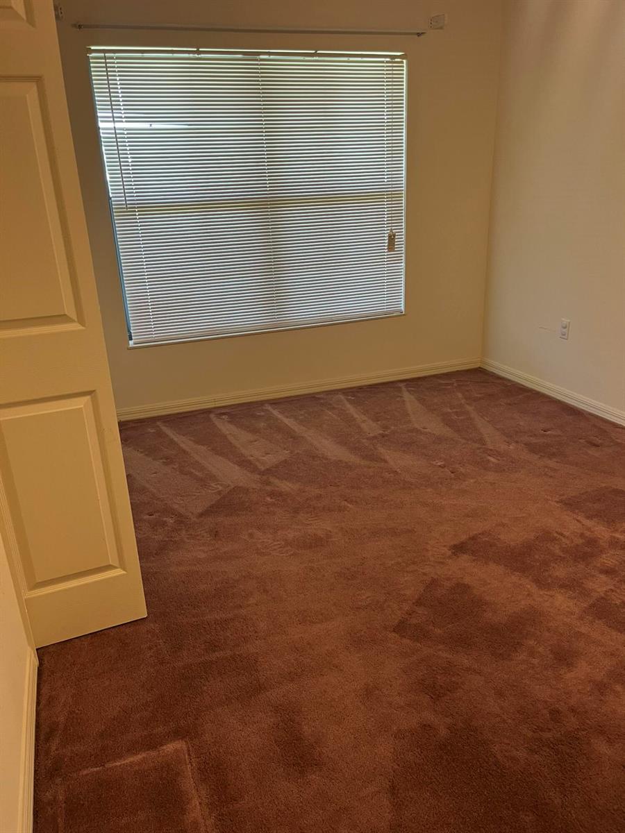 An empty room with brown carpet, beige walls, and a window with horizontal blinds — 8451 SW 14th Lane, Okeechobee FL 34974, OKEECHOBEE, FL