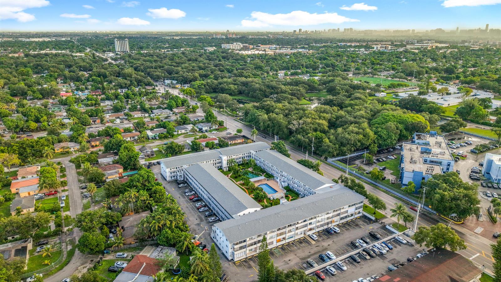 An aerial view shows a U-shaped apartment complex with a central courtyard and swimming pool — 15610 NE 6th Avenue # 37b, Miami FL 33162, MIAMI, FL