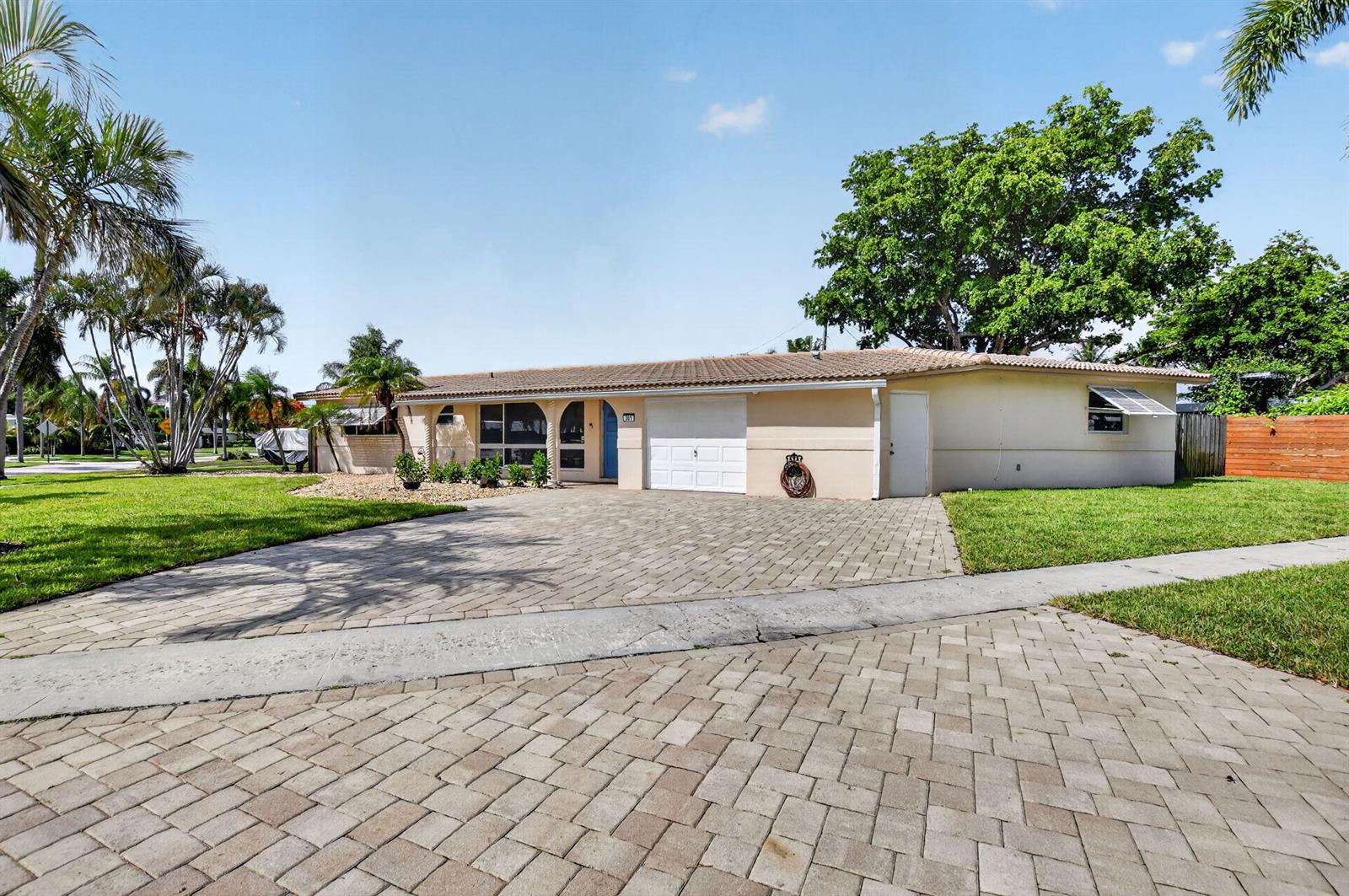 A single-story house with a paved driveway, a garage, and a large tree in front — 301 SE 8th Avenue, Deerfield Beach FL 33441, DEERFIELD BEACH, FL