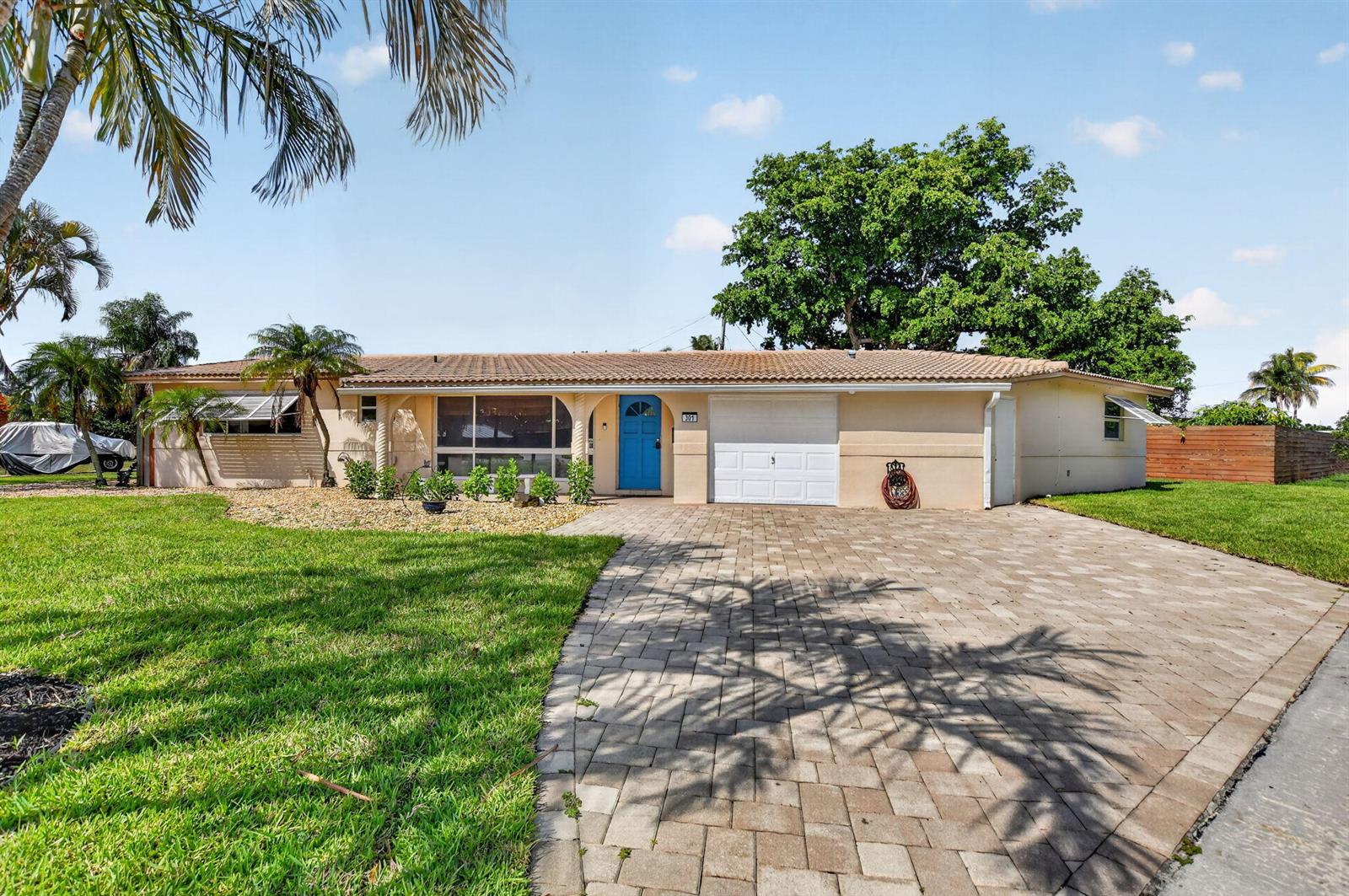 A single-story house with a blue front door, white garage, and a paved driveway — 301 SE 8th Avenue, Deerfield Beach FL 33441, DEERFIELD BEACH, FL