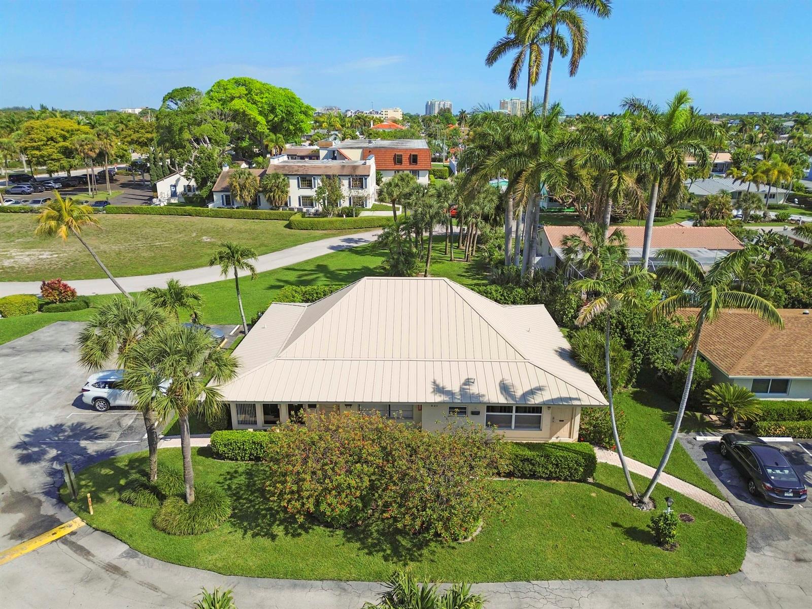 An aerial view of a single-story building with a metal roof surrounded by palm trees — 631 Snug Harbor Drive # S1, Boynton Beach FL 33435, BOYNTON BEACH, FL