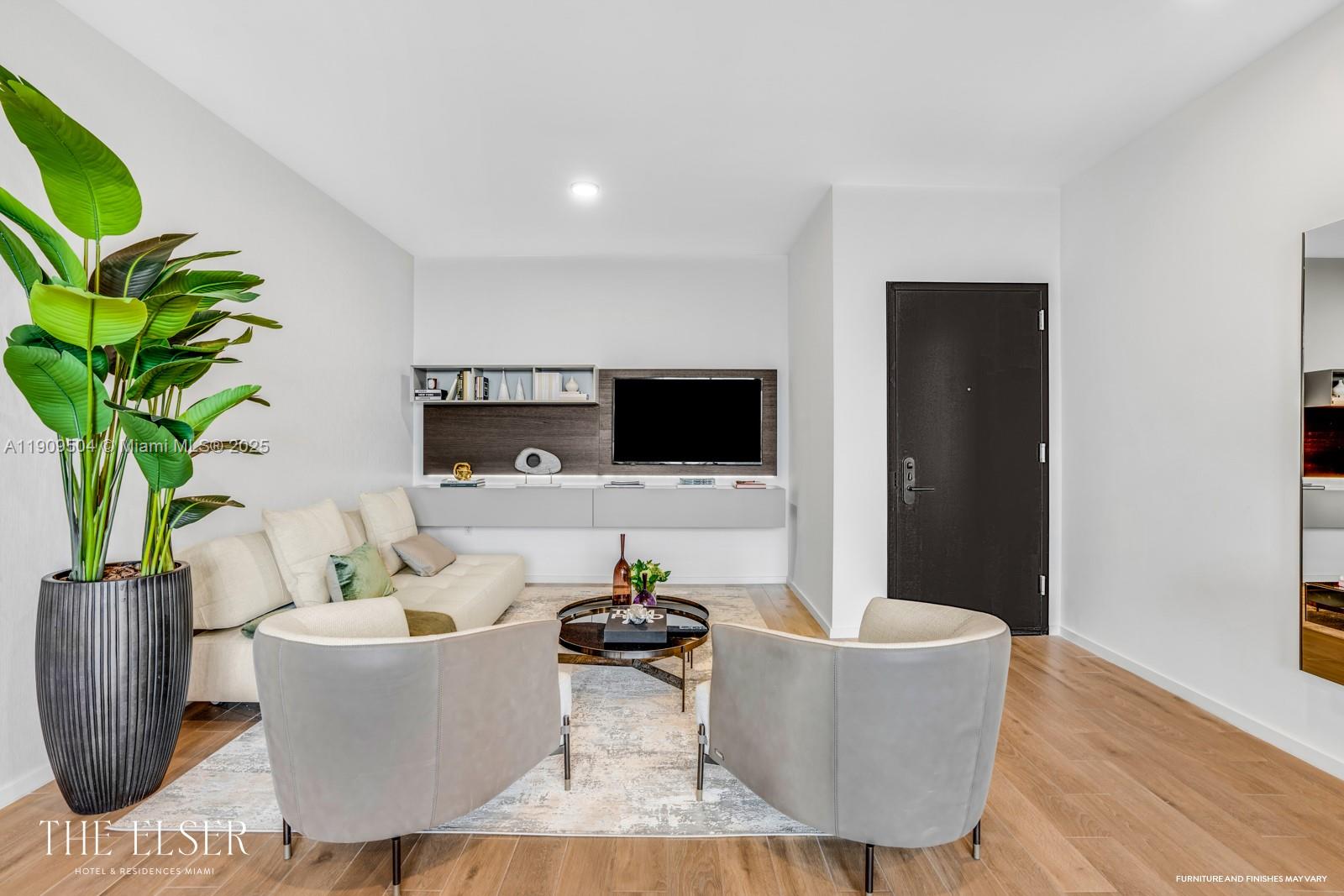 A modern living room features a sofa, two armchairs, a coffee table, and a wall-mounted television — 398 NE 5th St # 1601, Miami FL 33132, MIAMI, FL