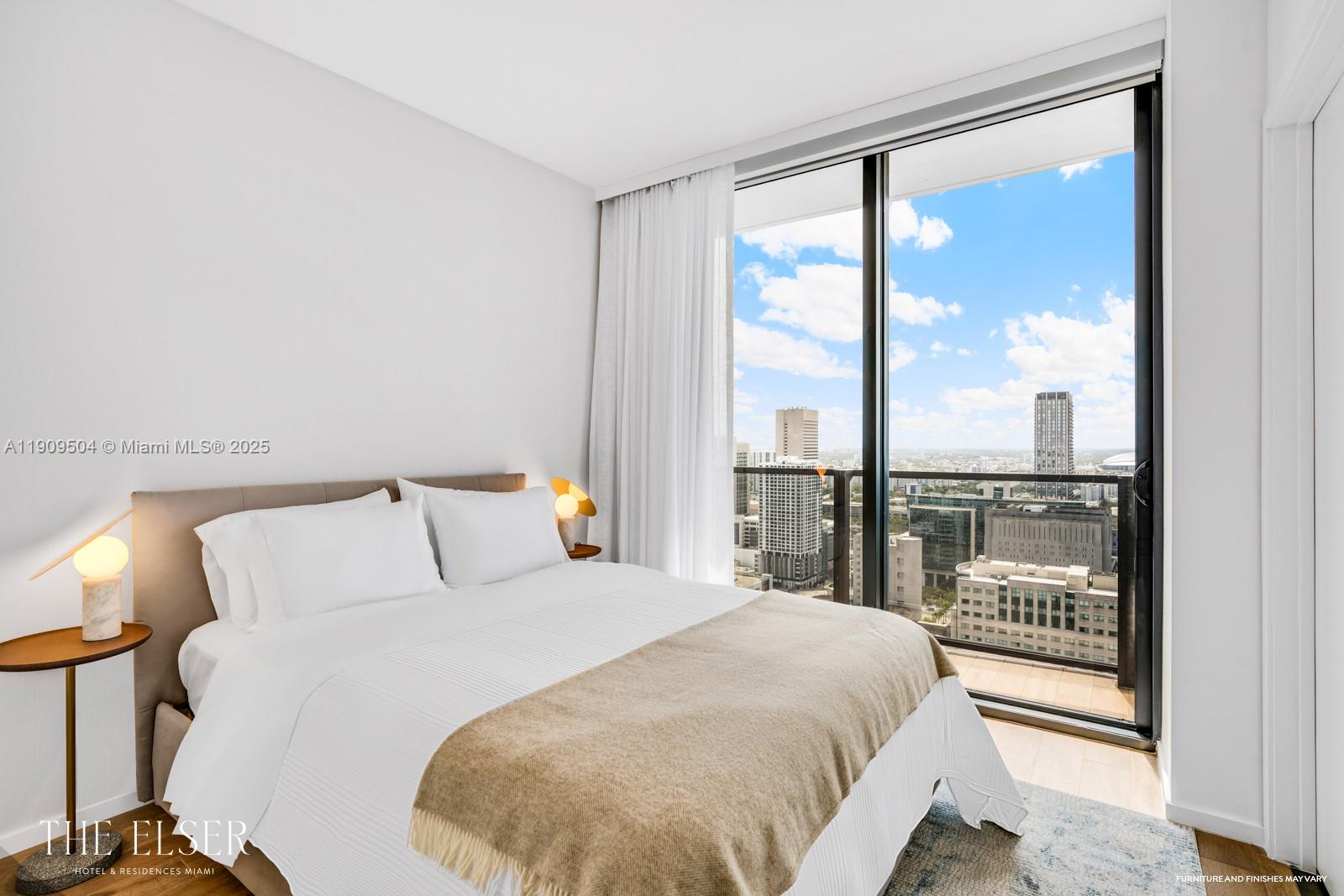A modern bedroom features a bed, two side tables with lamps, and a city view — 398 NE 5th St # 1601, Miami FL 33132, MIAMI, FL
