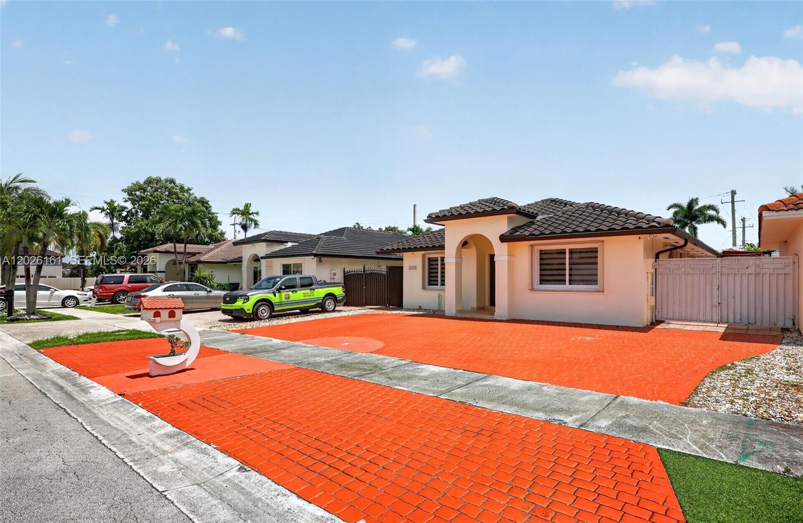 A single-story house with a bright orange paved driveway and a decorative mailbox — 12718 NW 6th Ln, Miami FL 33182, MIAMI, FL