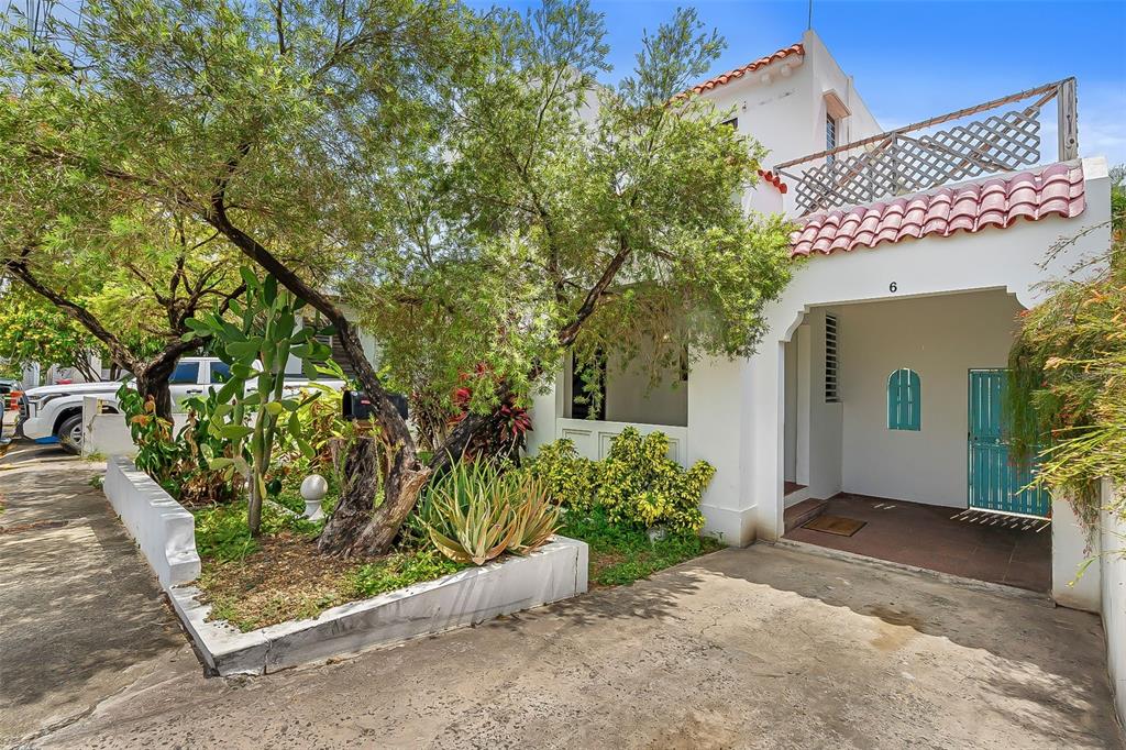 A white house with a red tile roof, a covered entryway, and a landscaped front yard — 6 GERTRUDIS, SAN JUAN, PR