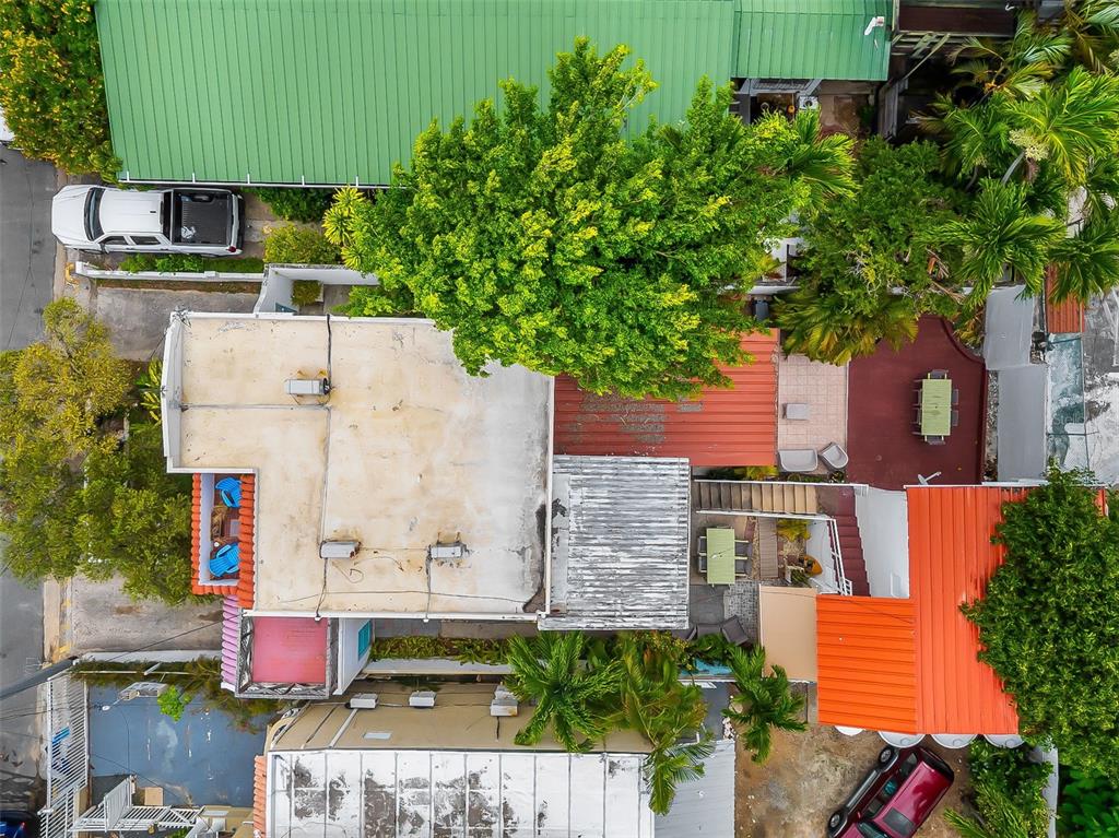 An aerial view shows a residential property with multiple roof sections, trees, and parked vehicles — 6 GERTRUDIS, SAN JUAN, PR