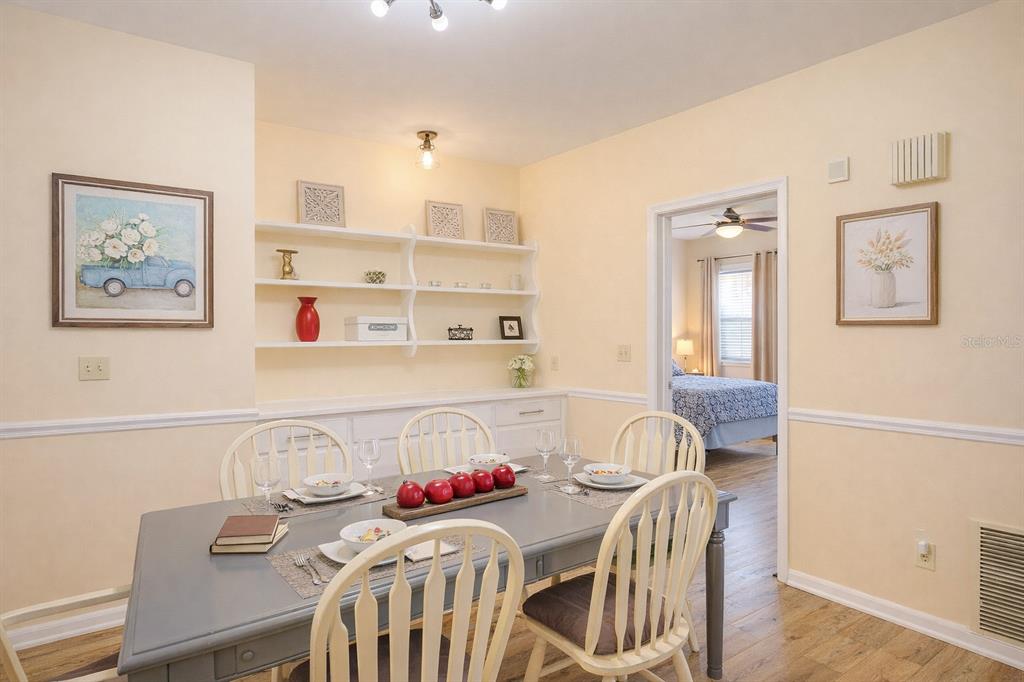 A dining room with a grey table, white spindle chairs, and built-in wall shelving — 501 S MAGNOLIA AVENUE UNIT 1, TAMPA, FL