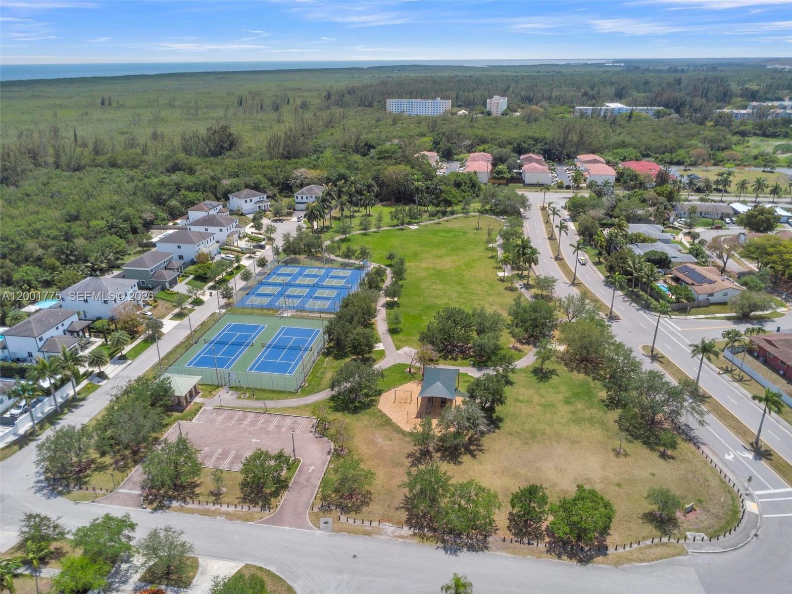 An aerial view shows a public park with tennis courts, a playground, and surrounding residential homes — 7810 SW 199th Ter, Cutler Bay FL 33189, CUTLER BAY, FL