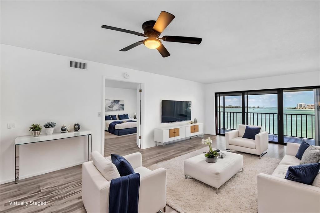 A living room with white furniture, a ceiling fan, and a balcony overlooking the water — 55 ROGERS STREET UNIT P5, CLEARWATER, FL