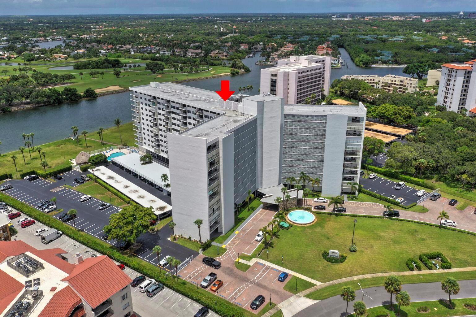 An aerial view of a multi-story residential building with a red arrow pointing to the roof — 336 Golfview Road # 203, North Palm Beach FL 33408, NORTH PALM BEACH, FL