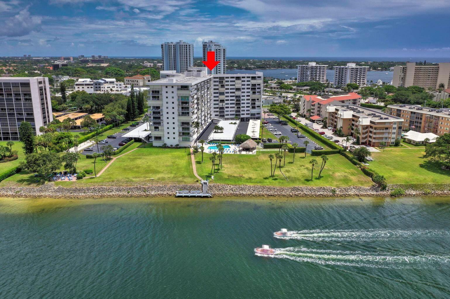 An aerial view of a waterfront apartment building with a pool and a boat dock — 336 Golfview Road # 203, North Palm Beach FL 33408, NORTH PALM BEACH, FL