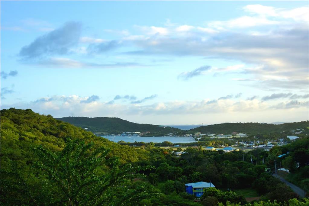 A high-angle view of a coastal town nestled between lush green hills and a bay — 5R MOUNT RESACA BARRIO FLAMENCO, CULEBRA, PR