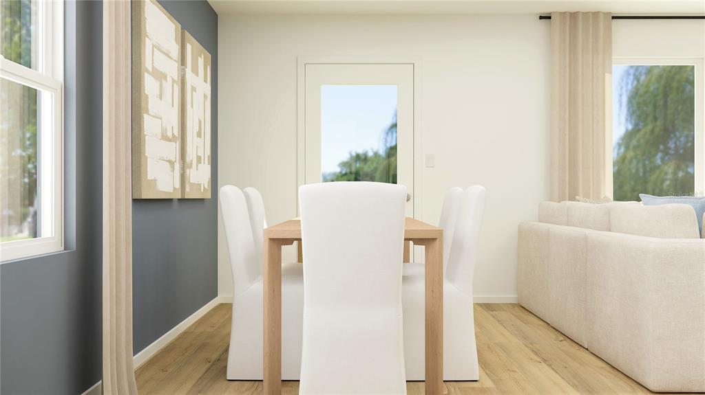 This is a digital rendering of a dining area featuring a table, chairs, and artwork — 2994 CHERRY LANE, HAINES CITY, FL