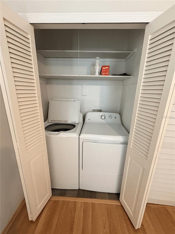 A laundry closet contains a top-loading washing machine and a dryer beneath two white shelves — 6693 ENGRAM ROAD, NEW SMYRNA BEACH, FL