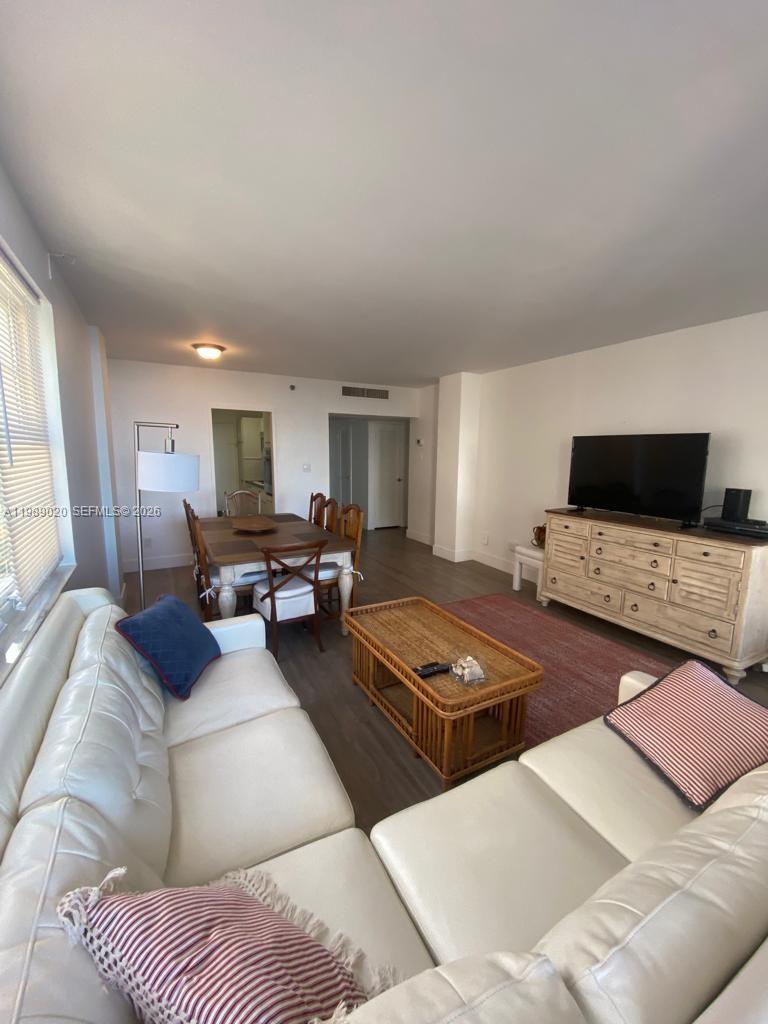 A living and dining area features white leather sofas, a wooden coffee table, and a dresser — 100 Lincoln Rd # 721, Miami Beach FL 33139, MIAMI BEACH, FL