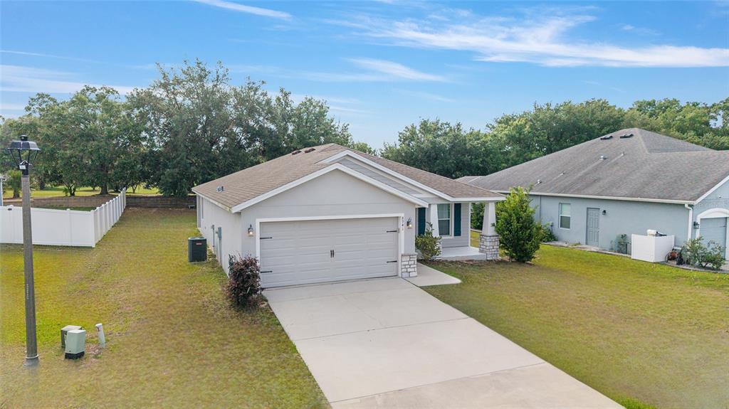 An exterior view of a single-story suburban house with a garage and a concrete driveway — 8941 SE 51ST, OCALA, FL