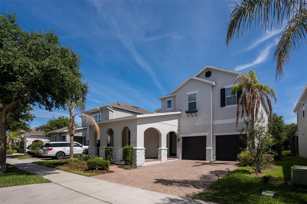 A two-story suburban house with a paved driveway, arched entryway, and two-car garage — 5024 PALMETTO PARK DRIVE, WINTER GARDEN, FL