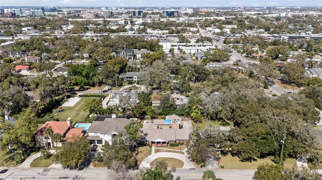 An aerial view shows several suburban houses with swimming pools and trees in a neighborhood — 4205 W AZEELE STREET, TAMPA, FL