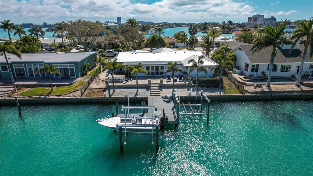 An aerial view of a waterfront house with a boat lift and private dock — 430 PALM ISLAND SE, CLEARWATER BEACH, FL