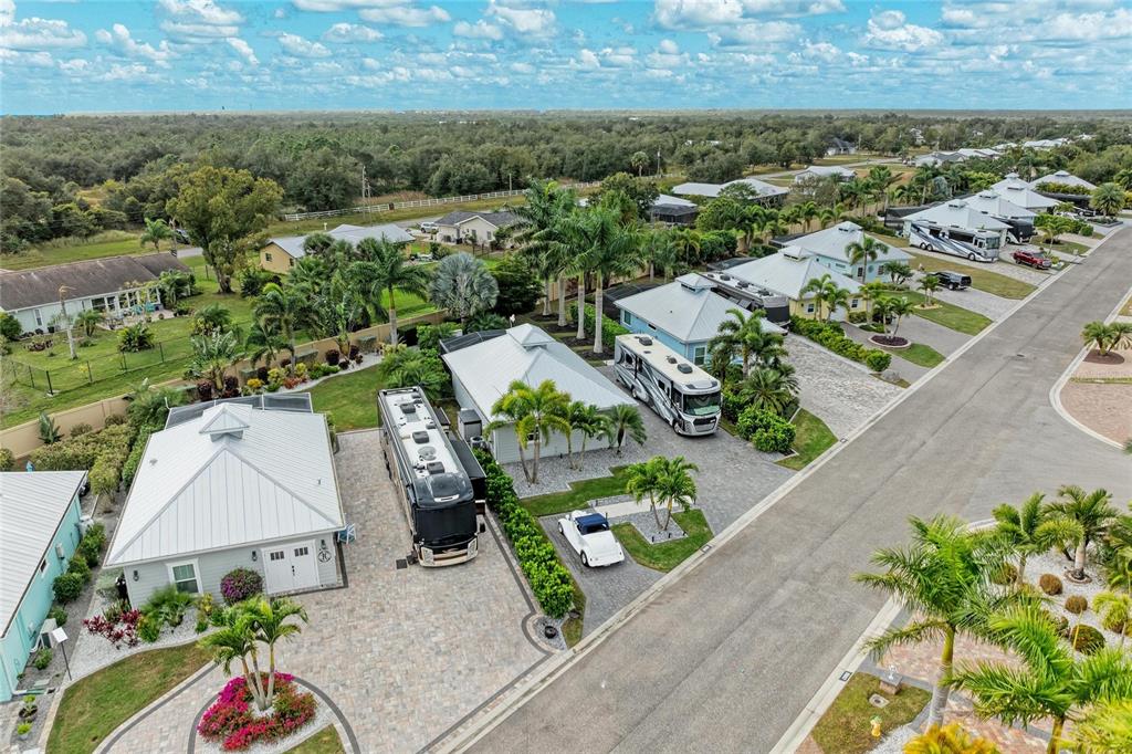 An aerial view shows several houses with attached RV garages and parked motorhomes — 8688 SW SAND CRANE CIRCLE LOT 44, ARCADIA, FL