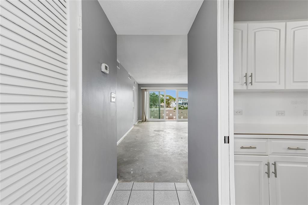 A view from a tiled entryway looking toward a living area with sliding glass doors — 1365 N SNELL ISLE BOULEVARD NE UNIT 2E, ST PETERSBURG, FL