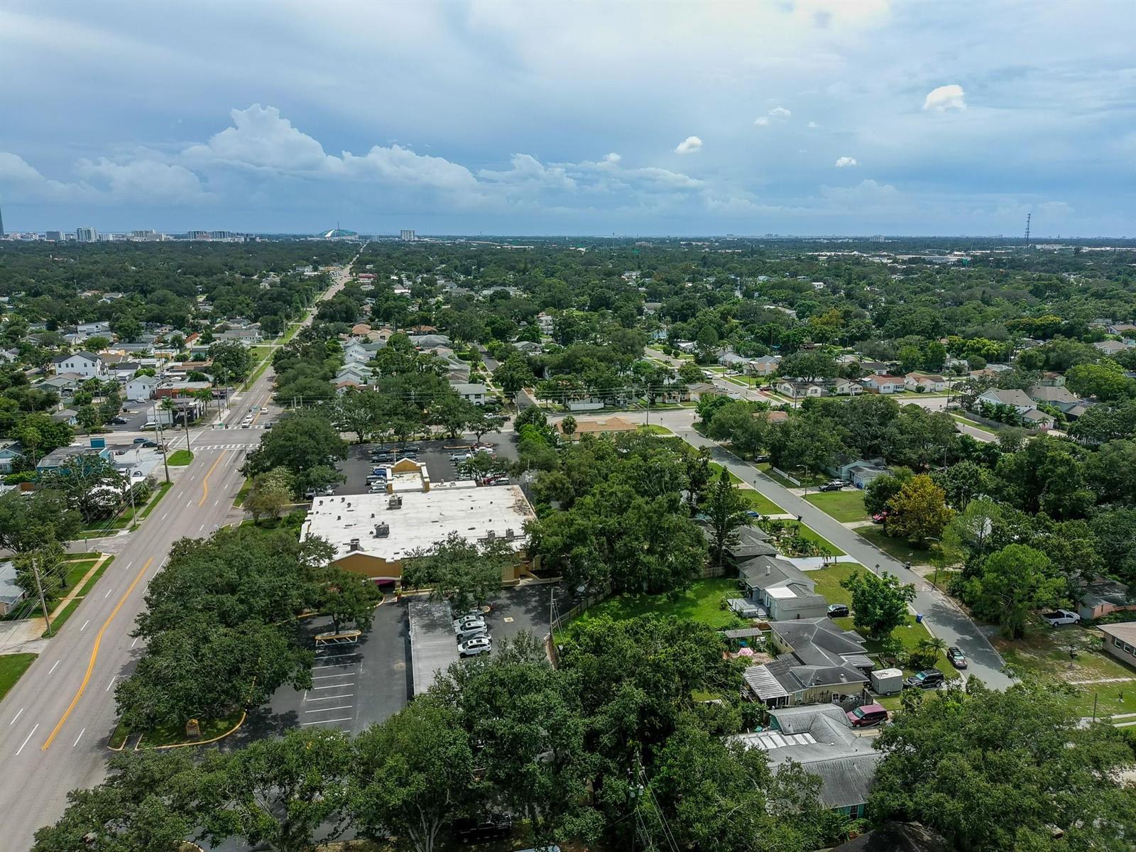 An aerial view shows a commercial building with a parking lot surrounded by residential neighborhoods — 4100 N 16th Street, FL 33703, FL