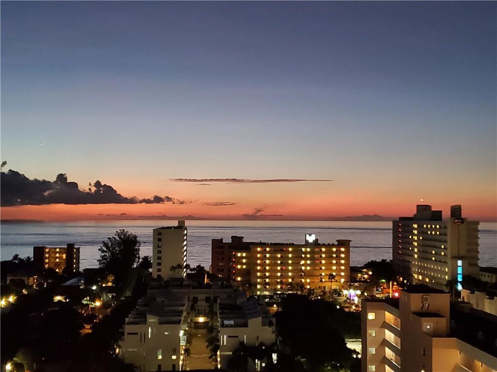 An elevated view of a coastal city skyline at sunset overlooking the ocean — 1401 N Riverside Drive # 807, Pompano Beach FL 33062, POMPANO BEACH, FL