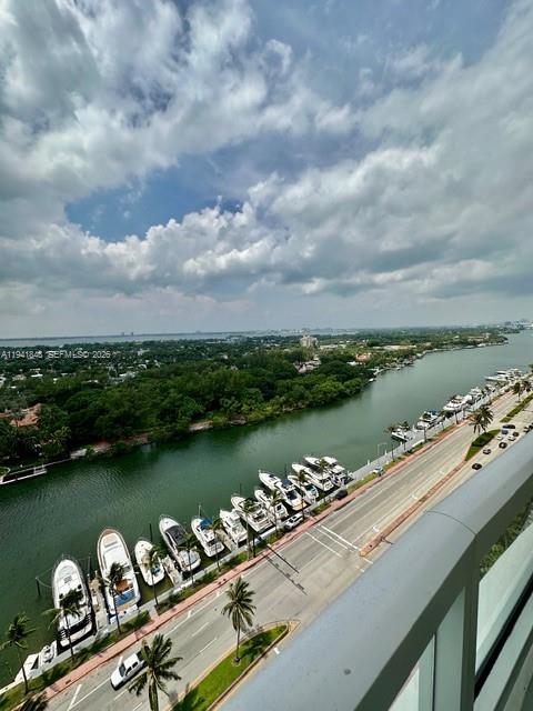 An elevated view shows a canal lined with docked boats next to a coastal road — 4401 Collins Ave # 1817, Miami Beach FL 33140, MIAMI BEACH, FL