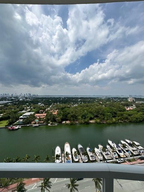 An elevated view shows a waterway lined with docked yachts and lush greenery under a cloudy sky — 4401 Collins Ave # 1817, Miami Beach FL 33140, MIAMI BEACH, FL