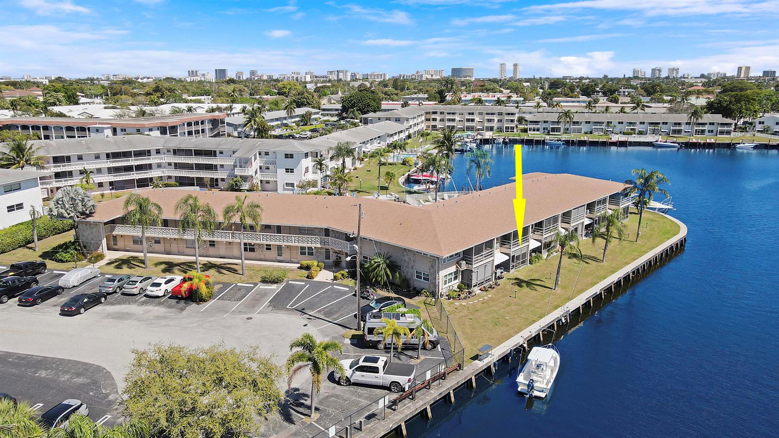 An aerial view shows a waterfront apartment building with a yellow arrow pointing to a balcony — 298 SE 6th Avenue # 6, Pompano Beach FL 33060, POMPANO BEACH, FL