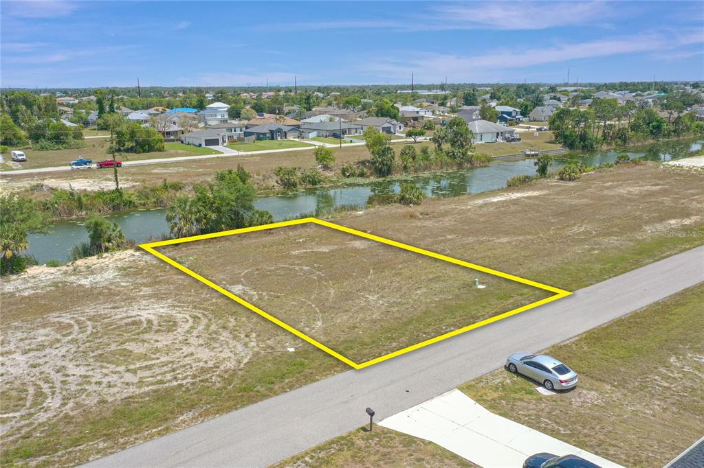 An aerial view of a vacant, rectangular residential lot bordering a canal — 3023 NE 5TH PLACE, CAPE CORAL, FL
