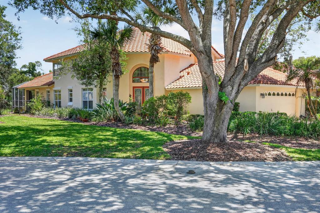 A two-story house with a tile roof, light-colored stucco, and a large front yard — 10 MONTERREY DRIVE, PALM COAST, FL