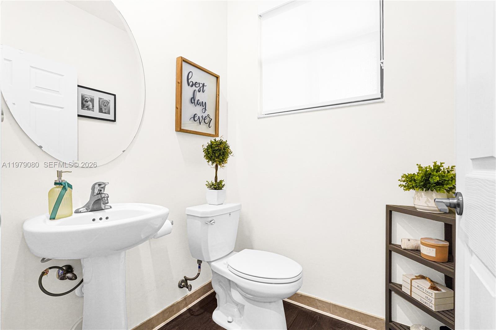 A small bathroom features a pedestal sink, a toilet, and a wooden shelving unit — 3321 W 105th Pl, Hialeah FL 33018, HIALEAH, FL