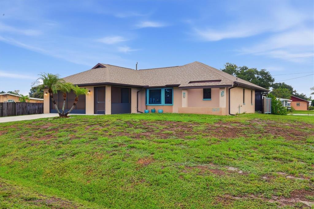 A single-story house with a tan exterior, a brown shingled roof, and a grassy front yard — 2671 YUCCA ROAD, VENICE, FL