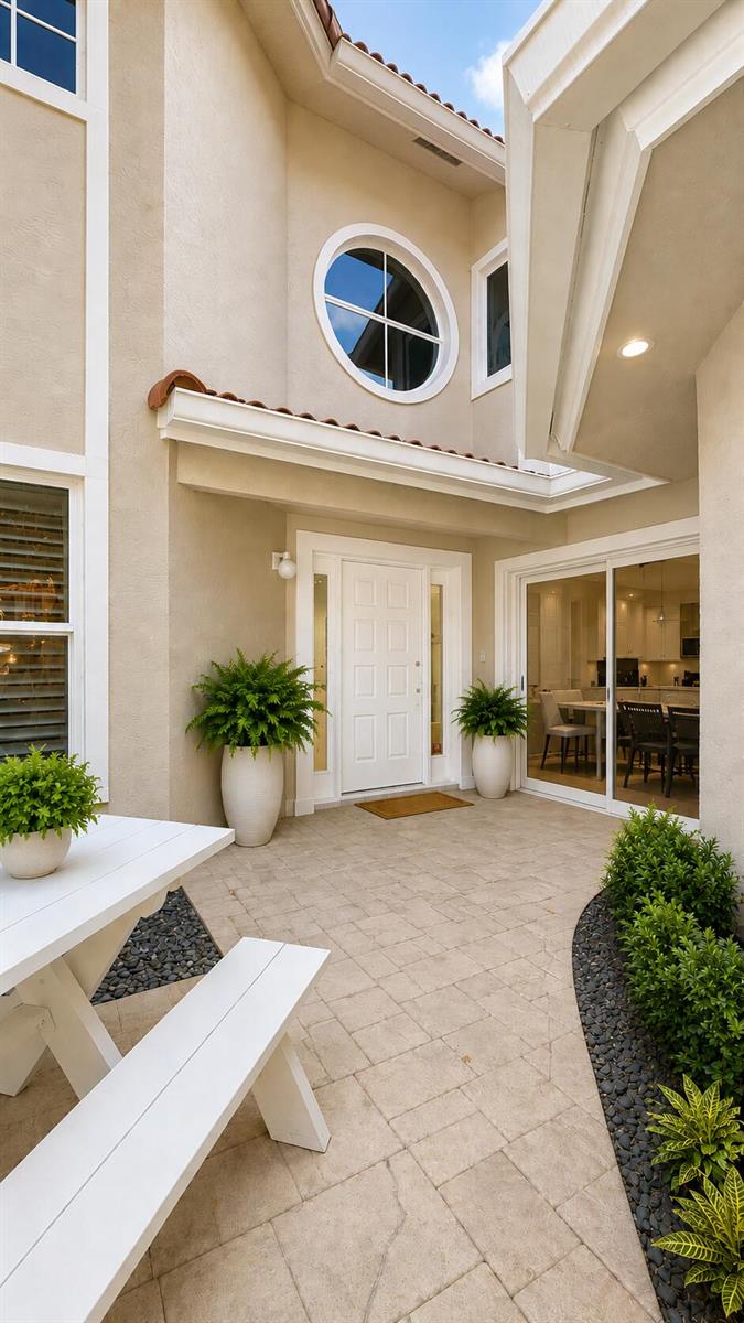 An exterior patio features a white front door, a sliding glass door, and a picnic table — 4107 Carriage Drive # K2, Pompano Beach FL 33069, POMPANO BEACH, FL