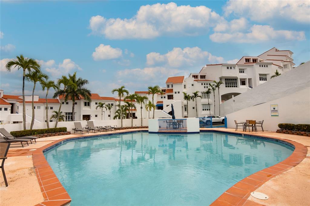 A swimming pool sits in front of white multi-story buildings with red tile roofs — 6000 RIO MAR BLVD VILLA LAS BRISAS UNIT 4A, RIO GRANDE, PR