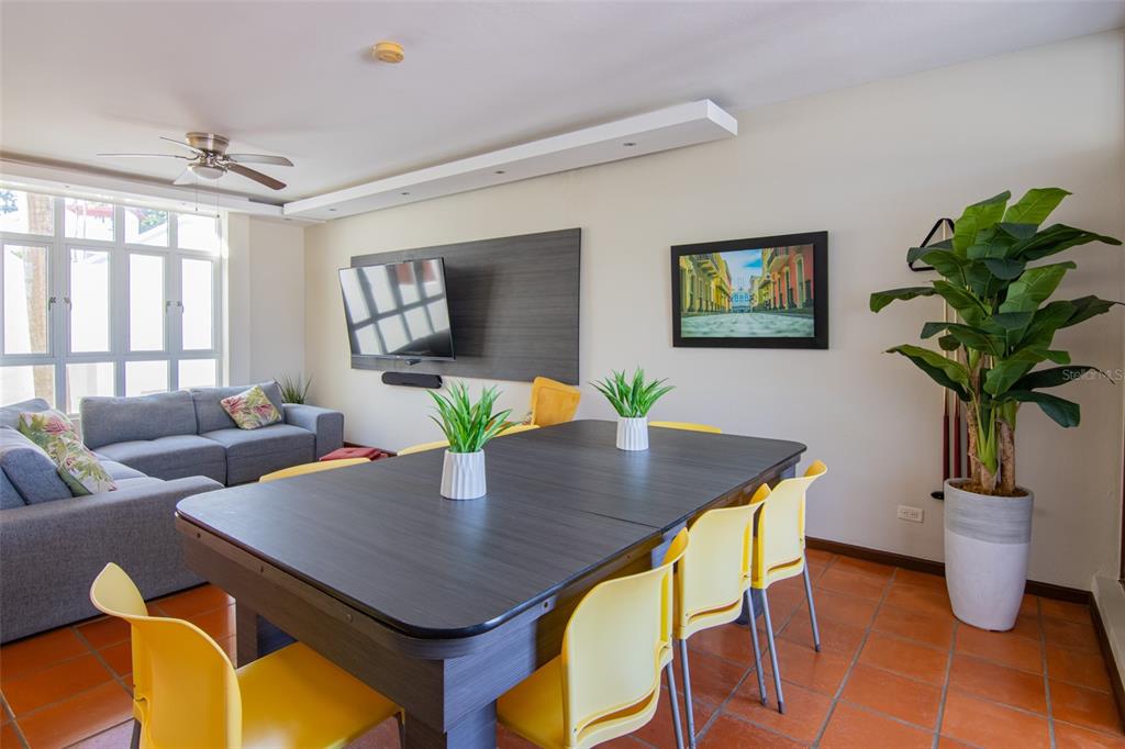 A living and dining room features a grey sectional sofa, a pool table, and yellow chairs — 6000 RIO MAR BLVD VILLA LAS BRISAS UNIT 4A, RIO GRANDE, PR