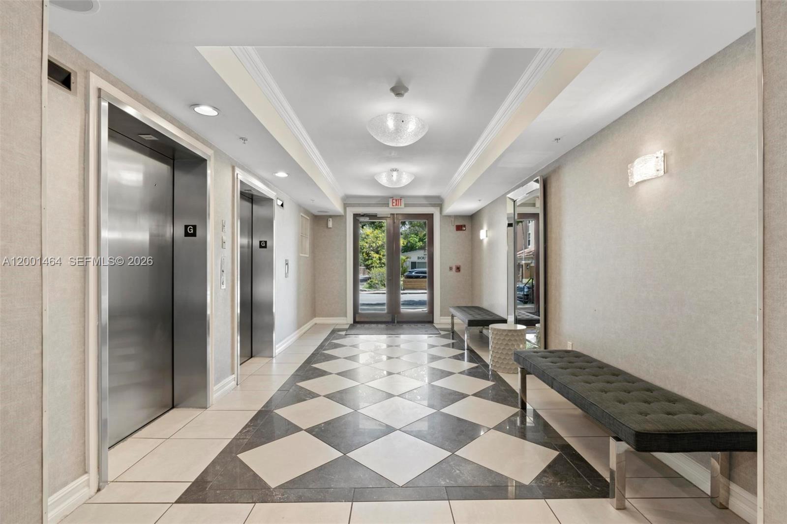 A building lobby features two elevators, a checkered floor, and a long bench — 1919 Van Buren St # 417A, Hollywood FL 33020, HOLLYWOOD, FL