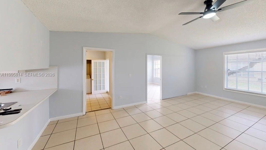 A tiled room features light blue walls, a ceiling fan, and two doorways — 9481 W Fern Ln, Miramar FL 33025, MIRAMAR, FL