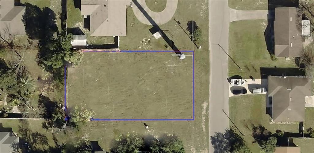 An aerial view shows a rectangular vacant residential lot outlined in blue — 250 WILLIAMS AVENUE, ORANGE CITY, FL