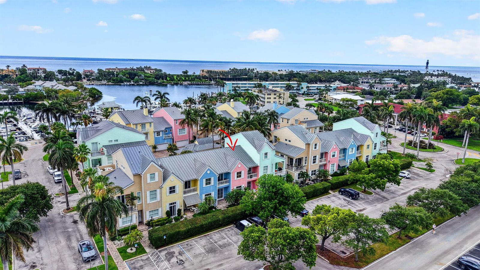 An aerial view shows a row of colorful townhouses with metal roofs near a marina — 2860 Marina Circle, Lighthouse Point FL 33064, LIGHTHOUSE POINT, FL