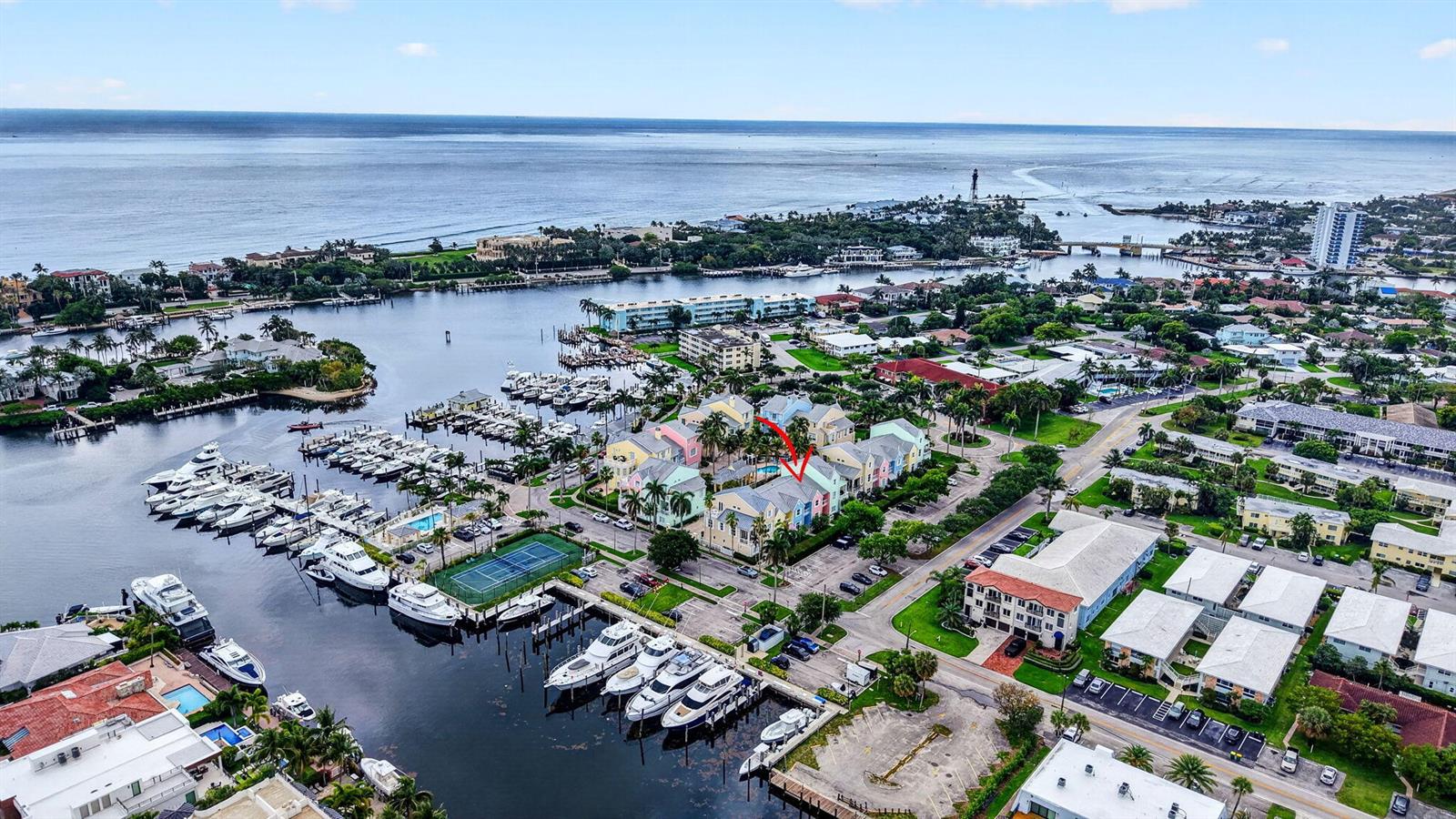 An aerial view shows a colorful waterfront residential complex with a marina and boats — 2860 Marina Circle, Lighthouse Point FL 33064, LIGHTHOUSE POINT, FL
