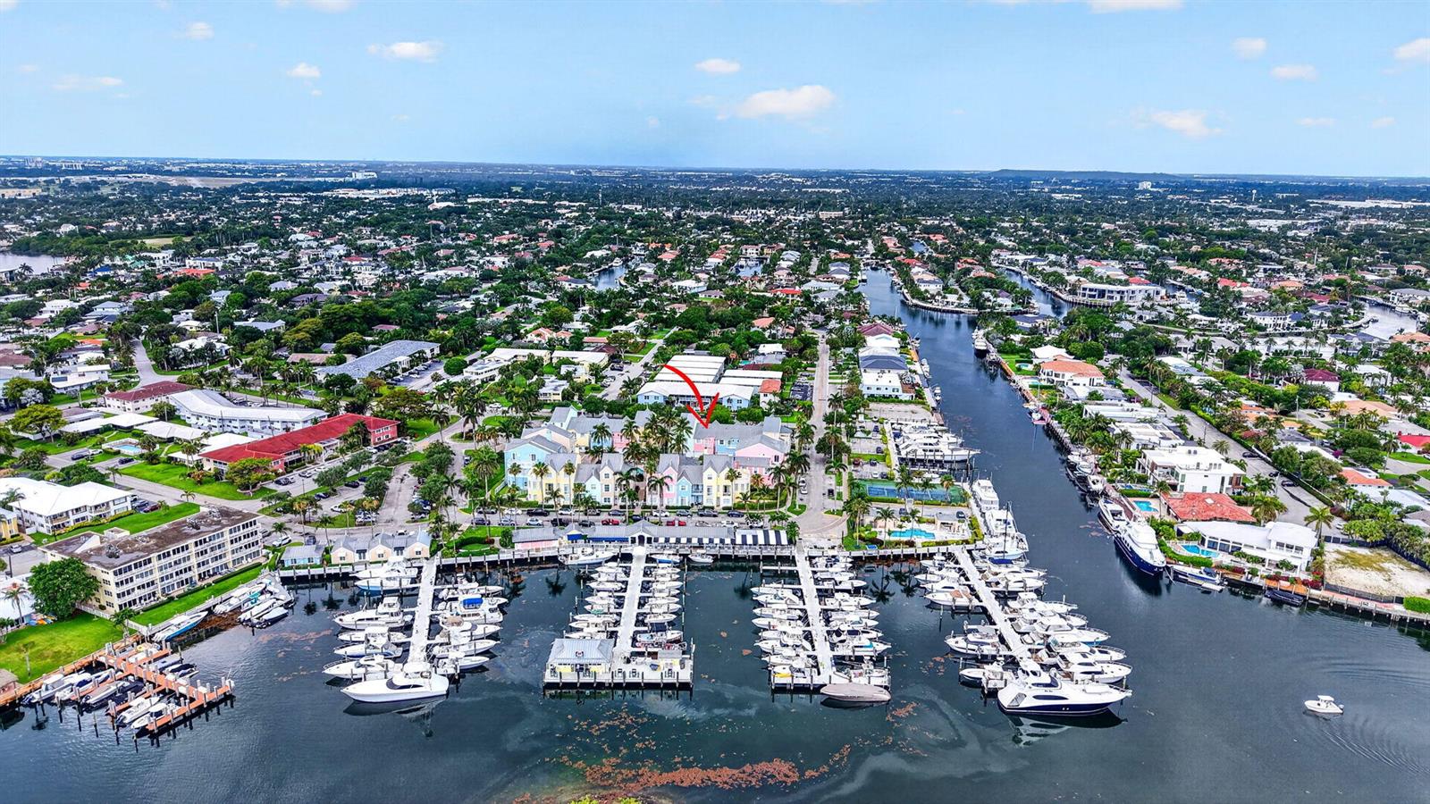 An aerial view shows a colorful waterfront residential complex with a private boat marina — 2860 Marina Circle, Lighthouse Point FL 33064, LIGHTHOUSE POINT, FL