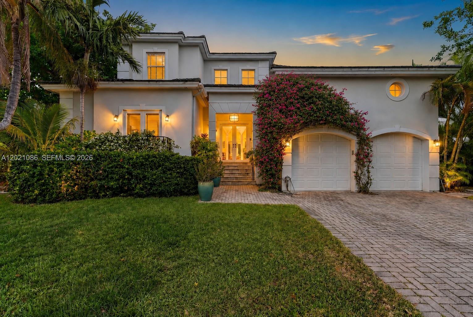 A two-story house with a paved driveway, two garage doors, and a bougainvillea-covered entryway — 442 Ridgewood Rd, Key Biscayne FL 33149, KEY BISCAYNE, FL