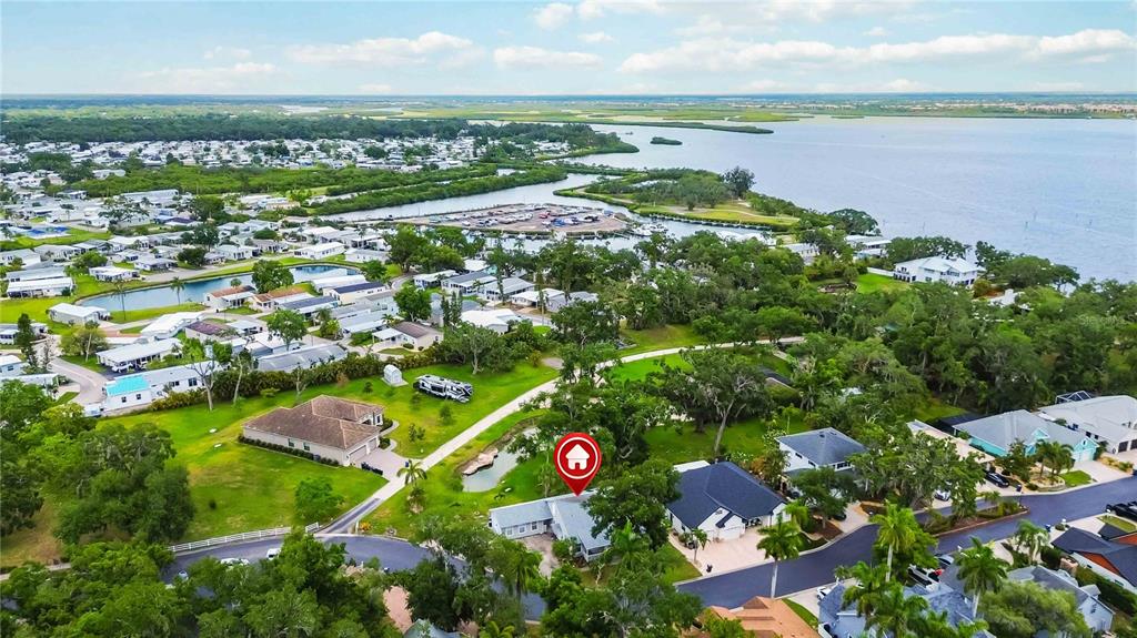 An aerial view shows a residential neighborhood with a house marked by a location pin — 2209 68TH DRIVE E, ELLENTON, FL