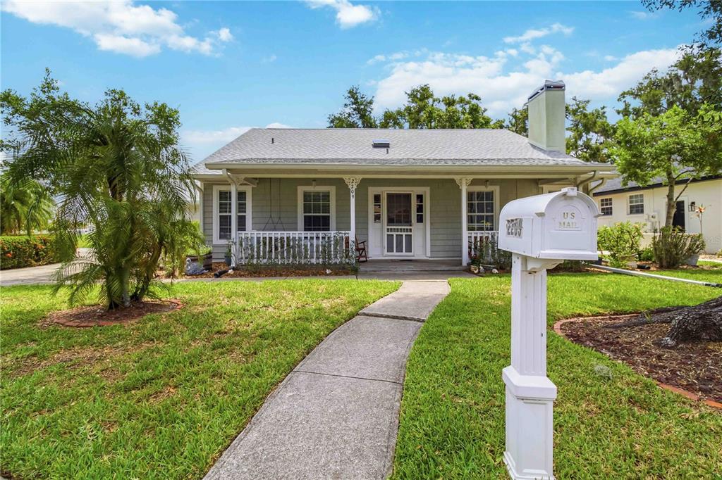A single-story house with light gray siding, a front porch, and a white mailbox — 2209 68TH DRIVE E, ELLENTON, FL