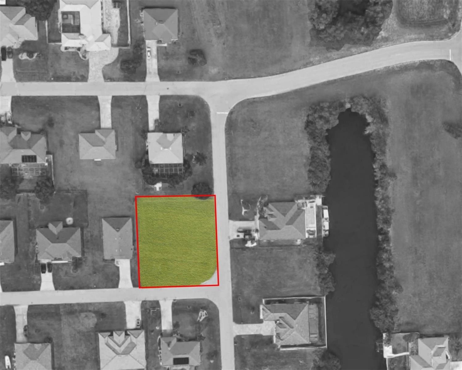 An aerial view shows a vacant, rectangular residential lot outlined in red within a neighborhood — 2101 SW 25th Terr Cape, FL 33914, FL