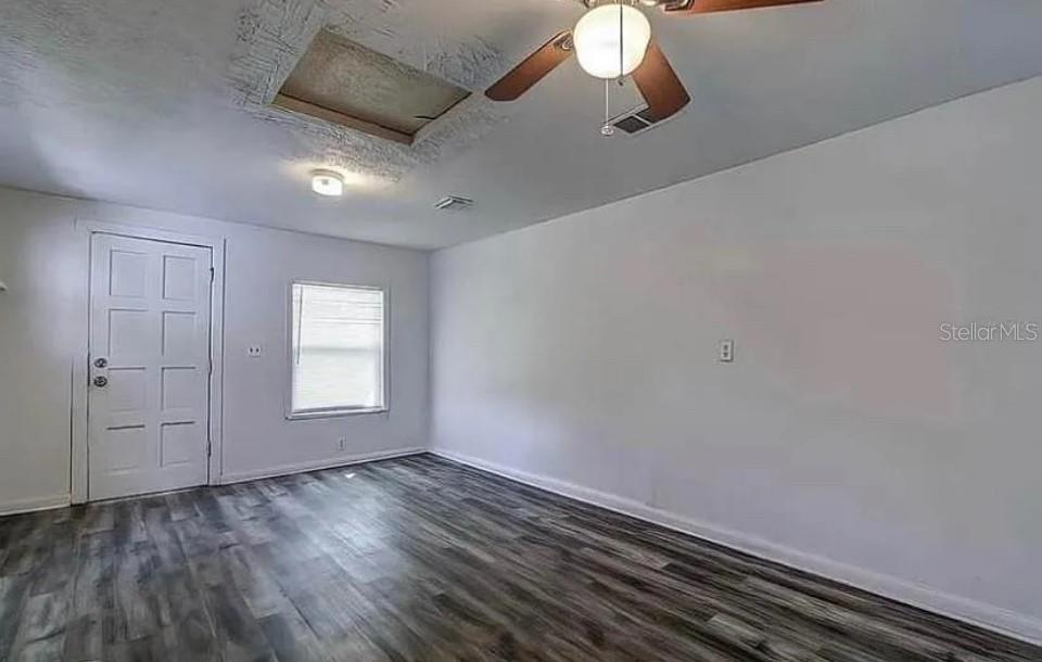 A kitchen features white cabinets, granite countertops, and a white electric range — 8428 N HIGHLAND AVENUE, TAMPA, FL