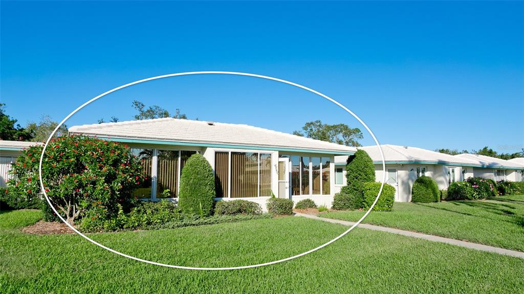 A single-story residential building with a tiled roof and large windows sits on a lawn — 6809 9TH AVENUE W UNIT 523, BRADENTON, FL