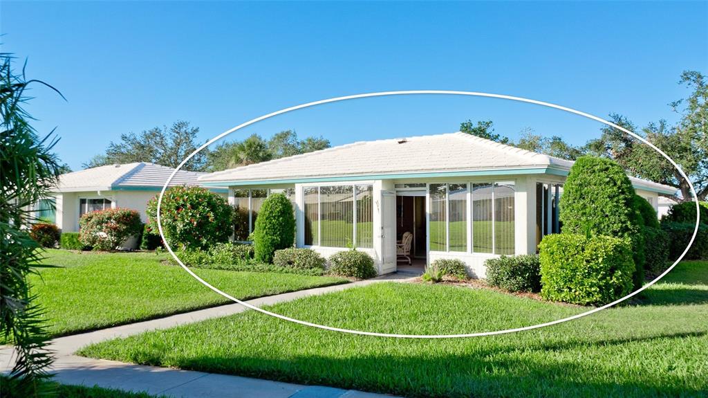 A single-story house with a white exterior, a tiled roof, and a glass-enclosed sunroom — 6809 9TH AVENUE W UNIT 523, BRADENTON, FL